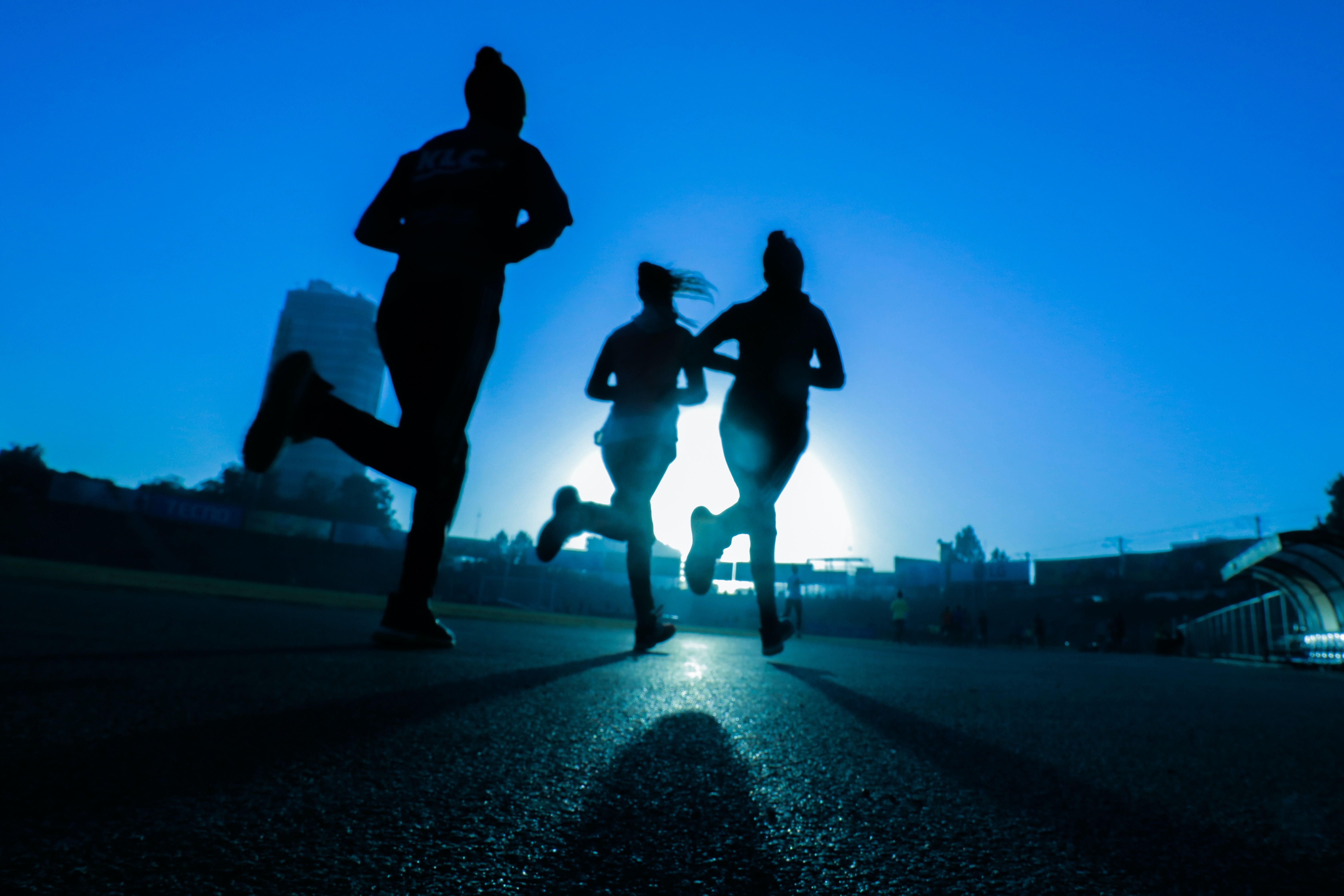 Image of three people running in the moonlight