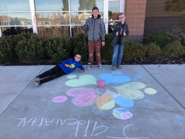 Students standing by chalk drawing for Unity Day.